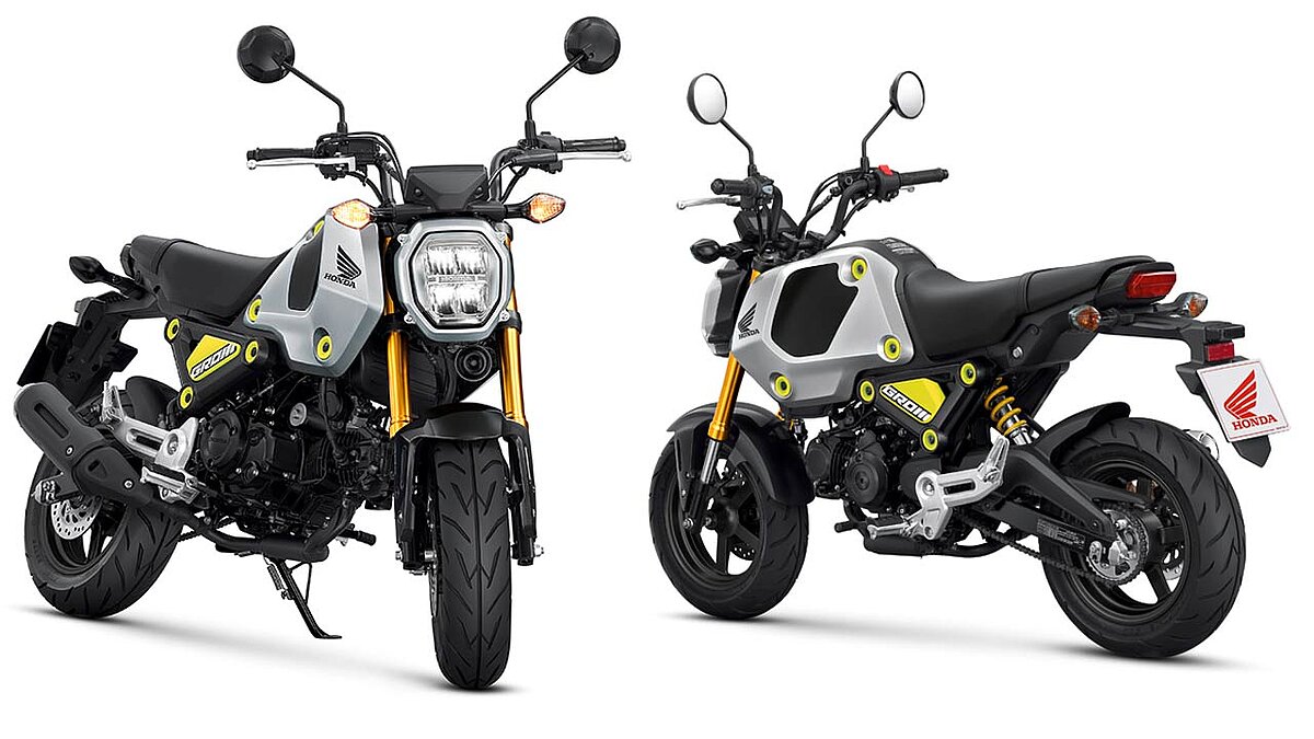 Hondas Zwerg-Motorrad MSX125 heißt künftig Grom – hier in der Farbe „Force Silver Metallic“ mit auffälligen Verkleidungsbefestigungen und einer nach Aufmerksamkeit heischenden Heckfeder in Gelb.